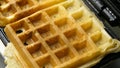 A homemade waffle finished baking on a waffle iron