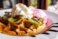 Homemade waffle served with strawberry ice cream and variety frui