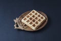 Homemade waffle on a wooden plate