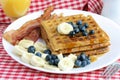 Homemade waffles, bacon, and fruit