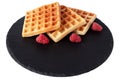 Homemade waffles with berries on black stone plate isolated. Belgian waffle with fruit raspberry on white background. Royalty Free Stock Photo