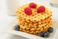 Homemade waffles with berries in plate on grey table Royalty Free Stock Photo