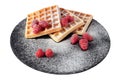 Homemade waffles with berries and sugar powder on black stone plate isolated. Belgian waffle with fruit raspberry on