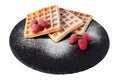 Homemade waffles with berries and sugar powder on black stone plate isolated. Belgian waffle with fruit raspberry on