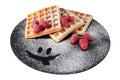 Homemade waffles with berries and sugar powder on black stone plate isolated. Belgian waffle with fruit raspberry on white Royalty Free Stock Photo