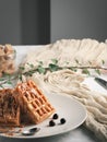 Homemade waffles with delicious caramel sauce on a plate. Belgian waffles with caramel and berries. Selective focus, vertical Royalty Free Stock Photo