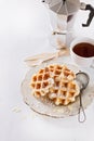 Homemade waffles over white wooden background