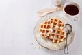 Homemade waffles over white wooden background