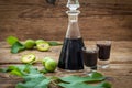 Homemade wallnut liquer on rustic wooden background