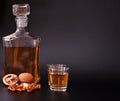 Homemade walnut liqueur, glass bottle and two glasses on a black background Royalty Free Stock Photo