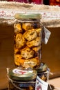 Homemade walnuts jam on wooden background in outdoor outside setting, during food festival. Natural feeling in direct sunlight,