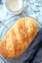 Homemade white bread, loaf of sourdough bread. Fresh loaf of bread and a glass jar with sourdough sourdough Royalty Free Stock Photo