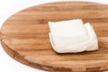Homemade white cheese on the kitchen wooden board Royalty Free Stock Photo