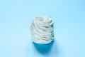 Homemade white marshmallow pastille on light blue background