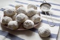 Homemade white mexican wedding cookies on pink plate, side view. Close-up Royalty Free Stock Photo