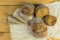 Homemade whole grain bread, wheat grains and spikelets. Wheat spikelets and bread. Spikelets of fresh wheat bread on a brown Royalty Free Stock Photo