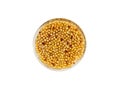 Homemade whole grain Dijon mustard with seeds in a glass round bowl isolated on white background top view. Royalty Free Stock Photo