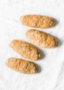 Homemade whole grain hot dogs rolls on a light background, top view. Buns for sandwiches