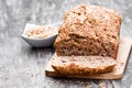 Homemade wholemeal rye bread with flax seeds on wooden table