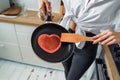 Homemade woman likes to cook delicious desserts from natural products. Making banana pancakes, turning over by wooden spatula the