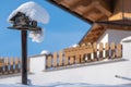 Homemade wooden bird`s feeder in winter under snow. The blu sky. Royalty Free Stock Photo