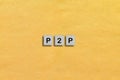 Homemade wooden tile with P2P abbreviation - peer-to-peer service is a decentralized platform whereby two individuals interact dir