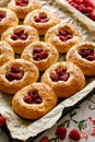 Homemade yeast buns with raspberries sprinkled with sesame seeds, close-up view Royalty Free Stock Photo