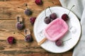 Homemade yoghurt ice cream eskim on stick with cherry Royalty Free Stock Photo
