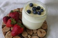 Homemade Yoghurt in a Jar with Fresh Strawberries and Blueberries on a Wooden Background Royalty Free Stock Photo