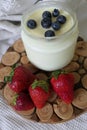 Homemade Yoghurt in a Jar with Fresh Strawberries and Blueberries on a Wooden Background Royalty Free Stock Photo