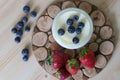 Homemade Yoghurt in a Jar with Fresh Strawberries and Blueberries on a Wooden Background Royalty Free Stock Photo