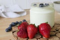 Homemade Yoghurt in a Jar with Fresh Strawberries and Blueberries on a Wooden Background Royalty Free Stock Photo