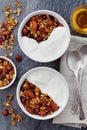 Homemade yogurt bowl with granola on black table, healthy and diet breakfast, from above