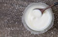 Homemade yogurt or sour cream on wooden with icing sugar background