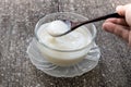 Homemade yogurt or sour cream on wooden with icing sugar background