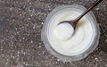 Homemade yogurt or sour cream on wooden with icing sugar background