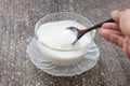 Homemade yogurt or sour cream on wooden with icing sugar background