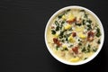 Homemade Zuppa Toscana with Kale and Bread in a white bowl on a black background, top view. Overhead, from above. Copy space Royalty Free Stock Photo