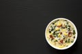 Homemade Zuppa Toscana with Kale and Bread in a white bowl on a black background, top view. Overhead, from above. Space for text Royalty Free Stock Photo