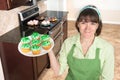 Homemaker holding cupcakes Royalty Free Stock Photo