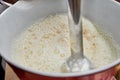 Homemaker Whisking Pancake Batter in Kitchen with Blender and Bowl Royalty Free Stock Photo