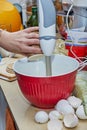 Homemaker Whisking Pancake Batter in Kitchen with Blender and Bowl Royalty Free Stock Photo