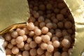 Homeopathic pellets in a container with an opened protective membrane.