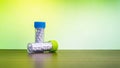 Homeopathic pills bottles on wood surface with green  mix yellow background Royalty Free Stock Photo