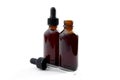 Homeopathic remedy and liquid tincture medicines concept with close up on two brown medicine glass bottles, one open and one