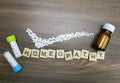 Homeopathy concept - Homeopathic medicine bottles with pills right mark made and Homeopathy text on wooden background