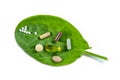 Homeopathy - A homeopathy concept with homeopathic medicine and food supplement on green leaves