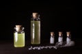 Homeopathy pills and oil in vintage bottles on blak background. A bottle of homeopathic remedies