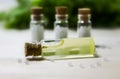 Homeopathy pills and oil in vintage bottles on wood and green background. Royalty Free Stock Photo