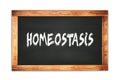 HOMEOSTASIS text written on wooden frame school blackboard